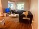 Comfortable living room featuring plush sofas, a white coffee table, and stylish decor at 6450 Alcalde Ct # 106, Orlando, FL 32835