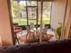 Inviting screened patio with a table, chairs, and a view of the lush outdoor space at 6450 Alcalde Ct # 106, Orlando, FL 32835