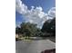Wide community street lined with trees, sidewalks, and lush landscaping at 6450 Alcalde Ct # 106, Orlando, FL 32835
