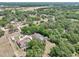 Expansive aerial view of a rural estate featuring lush greenery, multiple structures and a sparkling pool at 6686 Se 135Th St, Summerfield, FL 34491