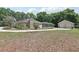Expansive backyard featuring a screened-in pool, three-car garage, and well-maintained landscaping at 6686 Se 135Th St, Summerfield, FL 34491