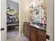 Bathroom vanity with a dark countertop, framed mirror, and overhead lighting at 6686 Se 135Th St, Summerfield, FL 34491