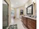Open bathroom layout featuring a shower and vanity area, leading to a tub room through an arched doorway at 6686 Se 135Th St, Summerfield, FL 34491