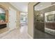 Elegant bathroom showcases a glass shower enclosure and a separate bathtub area for relaxation at 6686 Se 135Th St, Summerfield, FL 34491