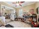 Bright bedroom with ceiling fan, carpet, and mirrored closet doors displaying lots of crafting and hobby supplies at 6686 Se 135Th St, Summerfield, FL 34491