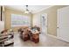 Bright room with tiled floor, ceiling fan, filled with stacked boxes and assorted items at 6686 Se 135Th St, Summerfield, FL 34491