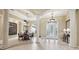 Elegant dining room with grand columns, decorative tile flooring, and a stylish chandelier at 6686 Se 135Th St, Summerfield, FL 34491