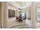 Formal dining area featuring elegant columns, chandelier, and a large window for ample natural light at 6686 Se 135Th St, Summerfield, FL 34491