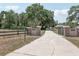 Long private driveway leading to the house, enhanced with stately brick columns and gated entries at 6686 Se 135Th St, Summerfield, FL 34491