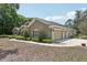 Attached three-car garage provides ample parking and storage space, complemented by tidy landscaping at 6686 Se 135Th St, Summerfield, FL 34491