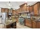 Kitchen with granite counters, gas range, stainless appliances, and ample cabinet storage at 6686 Se 135Th St, Summerfield, FL 34491
