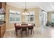 The eat-in kitchen area has tiled floors, chair railing, and lots of natural light at 6686 Se 135Th St, Summerfield, FL 34491