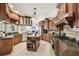 Well-lit kitchen features wood cabinetry, stainless steel appliances, and a central island at 6686 Se 135Th St, Summerfield, FL 34491