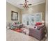 Cozy living room features high ceilings, a ceiling fan, and sliding doors leading to the outdoors at 6686 Se 135Th St, Summerfield, FL 34491
