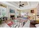 Bright living room features a ceiling fan, fireplace, and plush floral rug at 6686 Se 135Th St, Summerfield, FL 34491