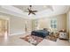 Large main bedroom with tray ceiling, ceiling fan, tiled flooring, and lots of natural light at 6686 Se 135Th St, Summerfield, FL 34491