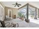 Covered patio with comfortable seating, a ceiling fan, and views of the pool at 6686 Se 135Th St, Summerfield, FL 34491
