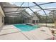 A refreshing pool with a soothing water feature, surrounded by lush greenery for privacy and relaxation at 6686 Se 135Th St, Summerfield, FL 34491