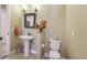 Powder room featuring a pedestal sink, tiled floors, and fresh flowers at 6686 Se 135Th St, Summerfield, FL 34491