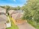 Aerial view of home with brick driveway, well-maintained yard, and tree coverage at 6837 Pasturelands Pl, Winter Garden, FL 34787