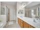 Bathroom featuring dual sinks, a separate shower and a soaking tub with tile surround at 6837 Pasturelands Pl, Winter Garden, FL 34787