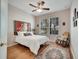 Cozy bedroom features a comfortable bed, ceiling fan, and natural light from two windows at 6837 Pasturelands Pl, Winter Garden, FL 34787
