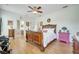 Spacious bedroom featuring hardwood floors, a ceiling fan, and two entryways at 6837 Pasturelands Pl, Winter Garden, FL 34787