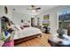 Bedroom featuring hardwood floors, natural light from the windows and tasteful decor at 6837 Pasturelands Pl, Winter Garden, FL 34787