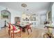 Dining room leading to the kitchen with a unique Tiffany-style light fixture and hardwood flooring at 6837 Pasturelands Pl, Winter Garden, FL 34787