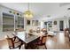 Well-lit dining room features hardwood flooring and views of the kitchen and living spaces at 6837 Pasturelands Pl, Winter Garden, FL 34787