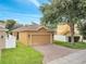 Exterior view of home featuring a two-car garage and brick paver driveway at 6837 Pasturelands Pl, Winter Garden, FL 34787