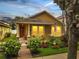 Charming single-Gathering home featuring a landscaped front yard and a cozy front porch with chairs at 6837 Pasturelands Pl, Winter Garden, FL 34787
