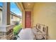 Welcoming front porch with cozy bench seating and a decorative wreath on the charming front door at 6837 Pasturelands Pl, Winter Garden, FL 34787