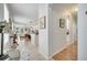 Bright hallway with an archway entrance leading to the kitchen and beautiful tile and wood flooring at 6837 Pasturelands Pl, Winter Garden, FL 34787