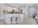 Modern kitchen featuring white cabinetry, a breakfast bar with seating, and stainless steel appliances at 6837 Pasturelands Pl, Winter Garden, FL 34787