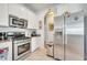 The kitchen features stainless steel appliances, light cabinets, and an adjoining hallway at 6837 Pasturelands Pl, Winter Garden, FL 34787