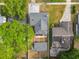 An aerial view of a gray home with a fenced yard and a brick patio connected to a detached living space at 731 Guernsey St, Orlando, FL 32804