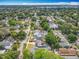 An aerial view of a tree-lined neighborhood with well-maintained homes and green spaces in a suburban setting at 731 Guernsey St, Orlando, FL 32804