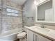 Bathroom featuring a shower, tub, vanity, quartz countertops, and classic fixtures at 731 Guernsey St, Orlando, FL 32804