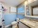 Bathroom with a sink, toilet, and combination washer/dryer unit at 731 Guernsey St, Orlando, FL 32804