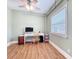 Light bedroom with a window providing natural light, complemented by wooden flooring and a white desk at 731 Guernsey St, Orlando, FL 32804