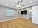 Bedroom featuring hardwood floors, natural light, a ceiling fan, and en-suite bathroom entrance at 731 Guernsey St, Orlando, FL 32804