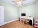 Bright bedroom featuring stylish wood flooring, a ceiling fan, and a white desk at 731 Guernsey St, Orlando, FL 32804