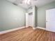 Inviting bedroom with light walls, sleek wooden flooring, and a spacious closet for storage at 731 Guernsey St, Orlando, FL 32804