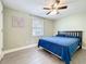 Bedroom featuring a large bed, ceiling fan, and light green walls at 731 Guernsey St, Orlando, FL 32804