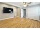 Bedroom with wood floors, ceiling fan, recessed lighting, closet, and en-suite bathroom entrance at 731 Guernsey St, Orlando, FL 32804
