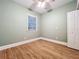 Cozy bedroom features light walls, wooden flooring, a window, and ample natural light at 731 Guernsey St, Orlando, FL 32804