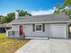 Charming single-story home features a gray exterior, red front door, and attached one car garage at 731 Guernsey St, Orlando, FL 32804