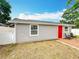 Charming house exterior with a red door and a brick patio for outdoor enjoyment at 731 Guernsey St, Orlando, FL 32804