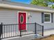Close up of the newly painted red front door with leaded glass oval window at 731 Guernsey St, Orlando, FL 32804